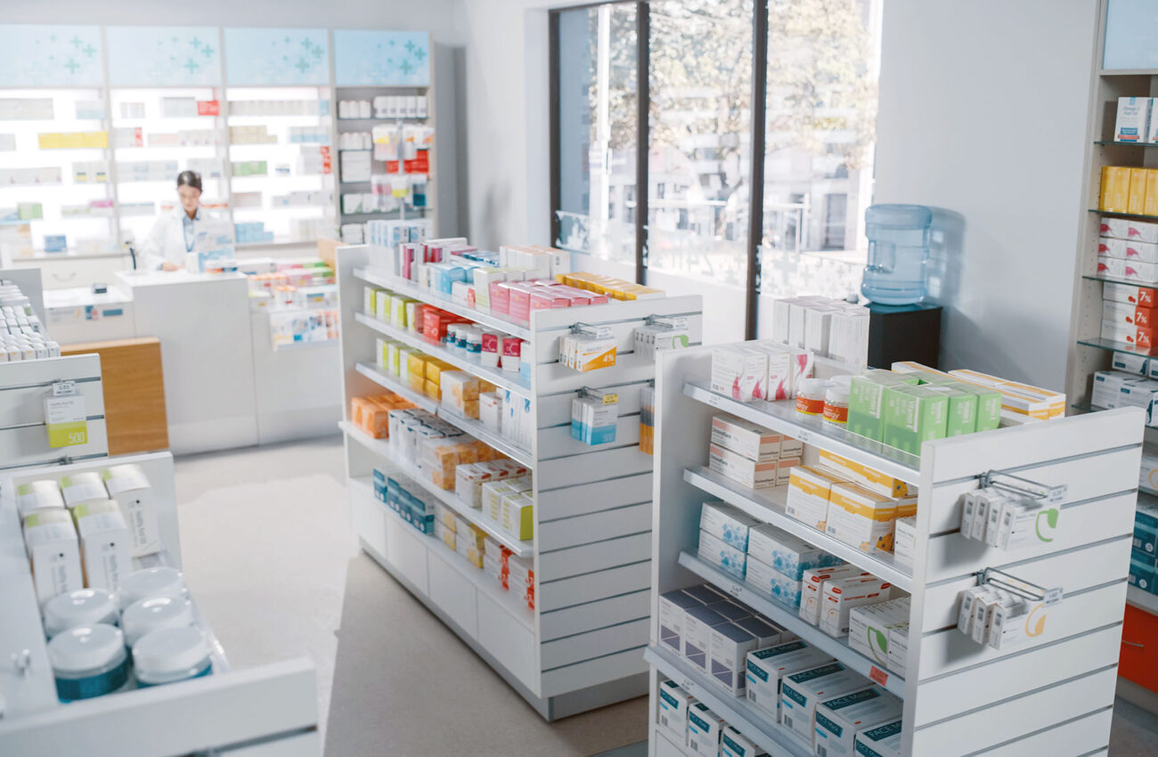 Big Modern Pharmacy Drugstore with Shelves full of Packages Full